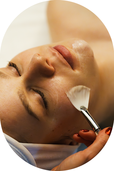 A woman touching her face happy with her classic facial.